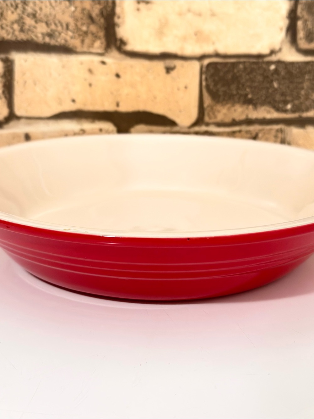 Le Creuset Red and Beige Round Pie Stoneware Plate